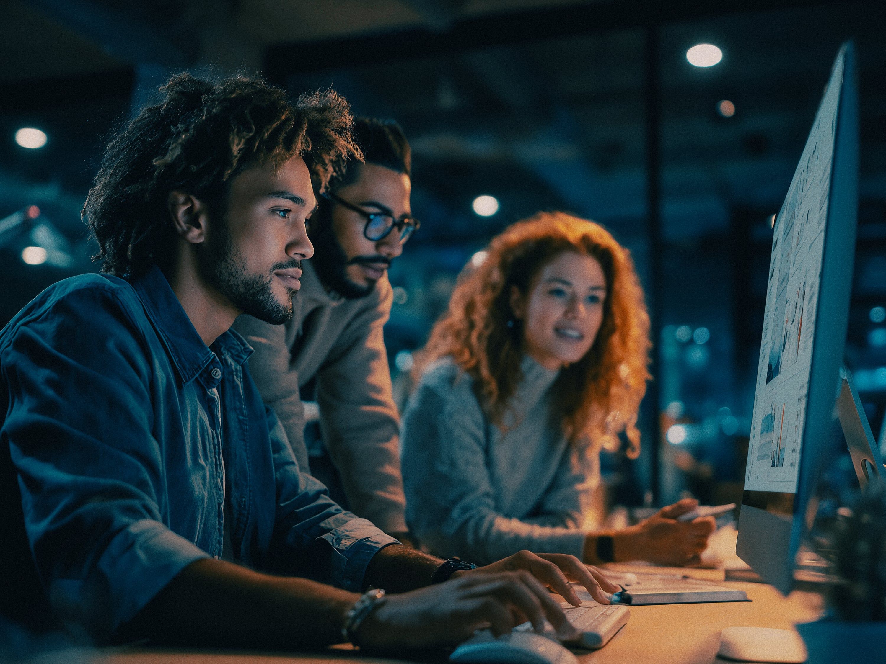 A marketing team working together at one shared workspace